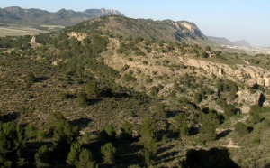 En el centro se observan areniscas marinas del Tortoniense superior. Al fondo, anticlinal del Cejo Cortado. A la derecha, presidido por el Pen de la Encantada, calizas del Eoceno 