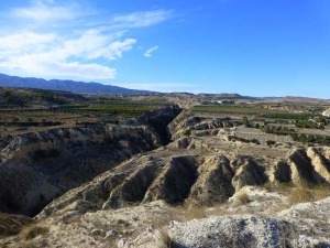 Ya en Fuente Librilla, la rambla homnima se estrecha y se encaja en el glacis que cubre gran parte de la llanura. Al fondo cerros originados por antiguos arrecifes de coral